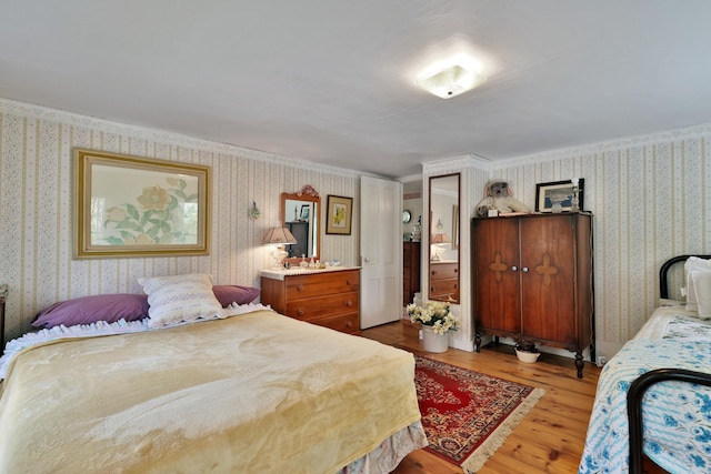 5100 Rte 100, Plymouth, VT 05056 - bedroom with wallpapered walls and light wood-style flooring
