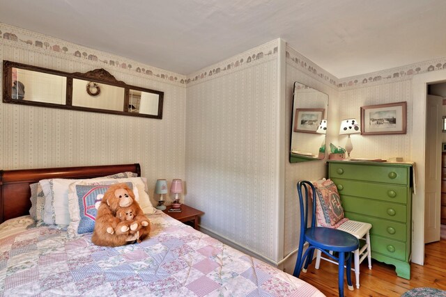5100 Rte 100, Plymouth, VT 05056 - bedroom featuring wood finished floors and wallpapered walls