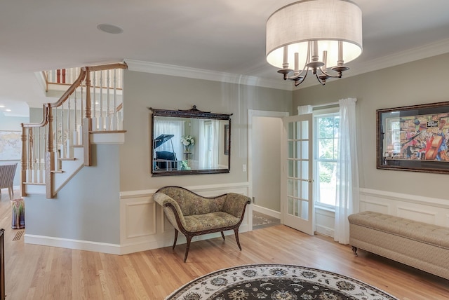 11 Clark Island Rd, Amherst, NH 03031 - sitting room with wood finished floors, a chandelier, stairs, crown molding, and wainscoting