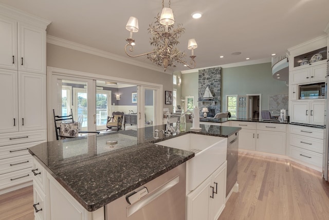 11 Clark Island Rd, Amherst, NH 03031 - kitchen with stainless steel appliances, light wood-style flooring, french doors, ornamental molding, and a kitchen island with sink