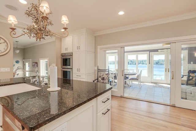 11 Clark Island Rd, Amherst, NH 03031 - kitchen featuring a sink, stainless steel double oven, french doors, ornamental molding, and light wood-style flooring