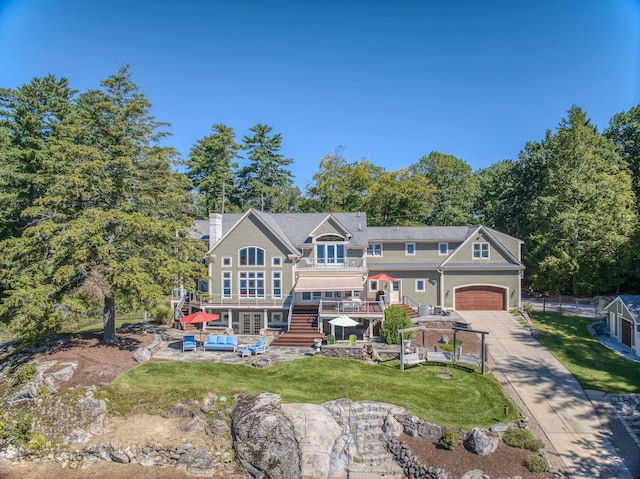 11 Clark Island Rd, Amherst, NH 03031 - view of front of home featuring concrete driveway, a wooden deck, a front lawn, a chimney, and stairs