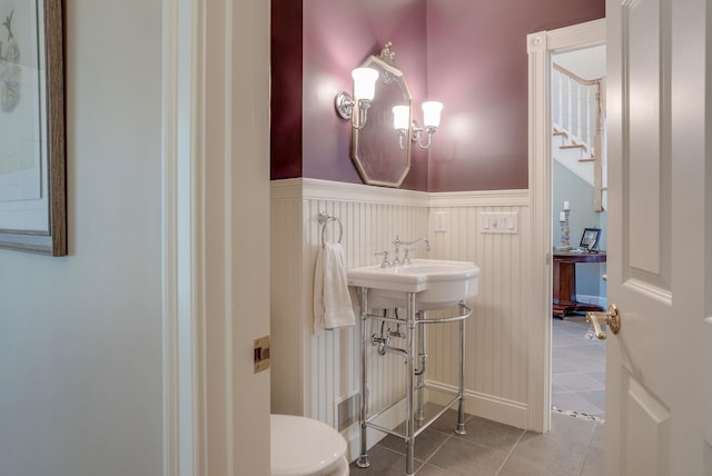 11 Clark Island Rd, Amherst, NH 03031 - half bathroom with a wainscoted wall, tile patterned flooring, toilet, and a sink