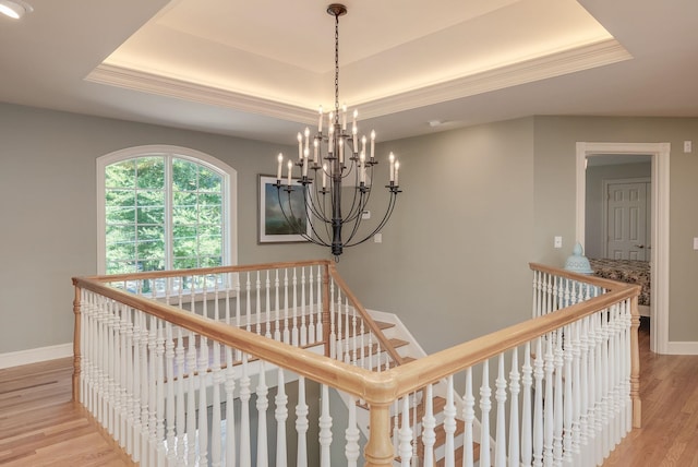 11 Clark Island Rd, Amherst, NH 03031 - stairway featuring a tray ceiling, a chandelier, wood finished floors, and baseboards