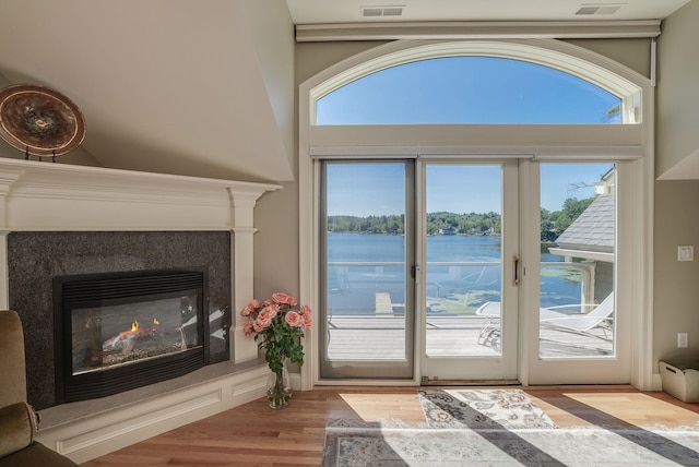 11 Clark Island Rd, Amherst, NH 03031 - doorway with a water view, healthy amount of natural light, a premium fireplace, and wood finished floors