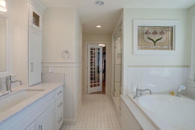 11 Clark Island Rd, Amherst, NH 03031 - bathroom featuring wainscoting, tile patterned floors, a garden tub, vanity, and recessed lighting