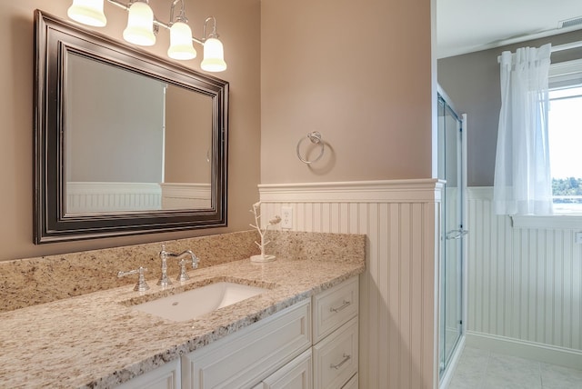 11 Clark Island Rd, Amherst, NH 03031 - bathroom with wainscoting, vanity, and tile patterned flooring