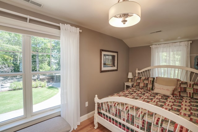 11 Clark Island Rd, Amherst, NH 03031 - bedroom featuring multiple windows, light wood-style flooring, baseboards, and vaulted ceiling