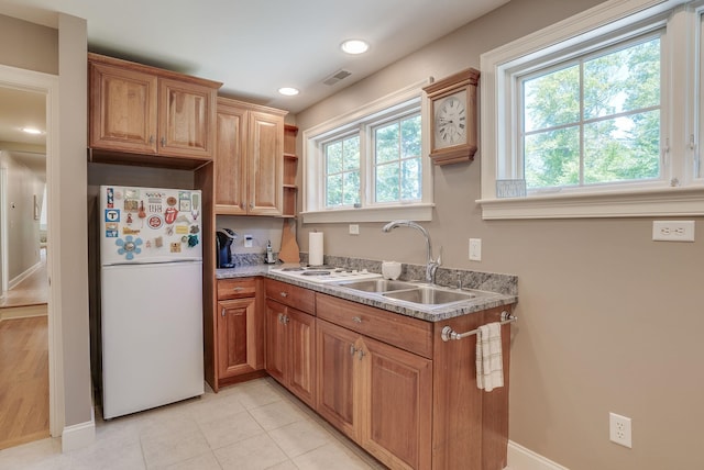 11 Clark Island Rd, Amherst, NH 03031 - kitchen featuring freestanding refrigerator, a sink, baseboards, brown cabinets, and recessed lighting