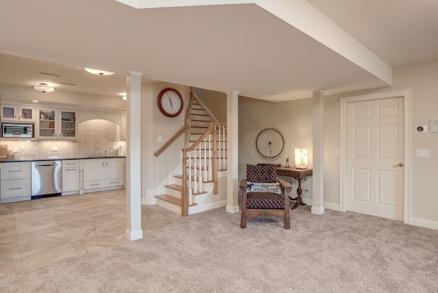 11 Clark Island Rd, Amherst, NH 03031 - sitting room with stairs, wet bar, baseboards, and light colored carpet