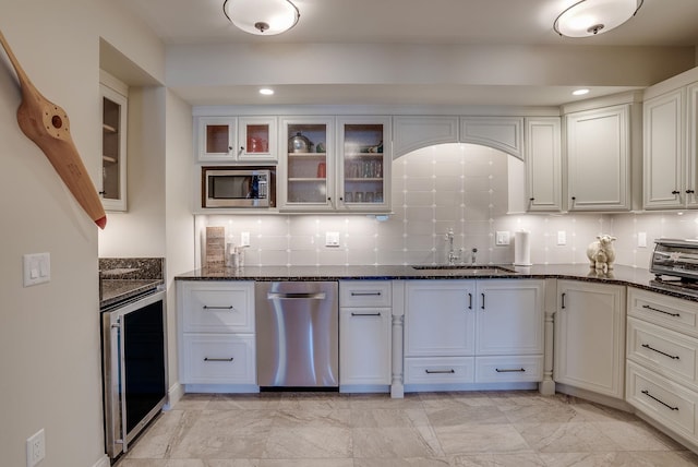 11 Clark Island Rd, Amherst, NH 03031 - kitchen with appliances with stainless steel finishes, a sink, wine cooler, dark stone counters, and tasteful backsplash