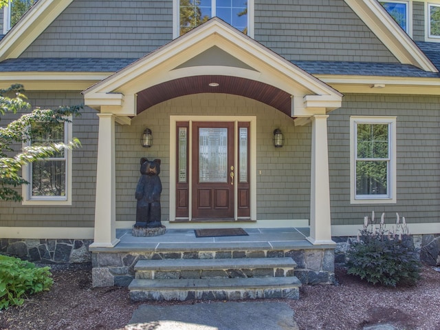 11 Clark Island Rd, Amherst, NH 03031 - view of exterior entry featuring a shingled roof and covered porch