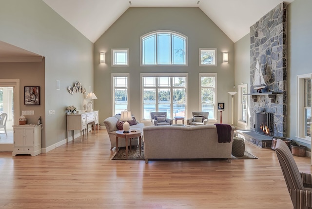 11 Clark Island Rd, Amherst, NH 03031 - living area with light wood-style flooring, a fireplace, and high vaulted ceiling