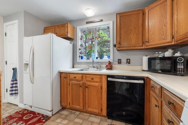 37 Thorndike Rd, Weare, NH 03281 - kitchen with black appliances, a sink, brown cabinets, and light countertops