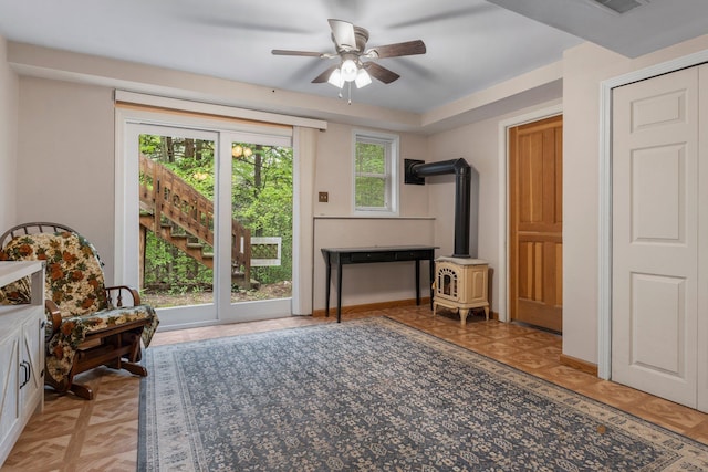 37 Thorndike Rd, Weare, NH 03281 - living area with a wood stove, a ceiling fan, and baseboards