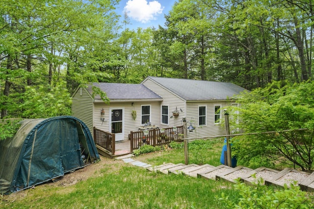 37 Thorndike Rd, Weare, NH 03281 - back of property with a wooden deck and roof with shingles