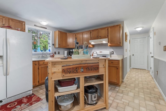 37 Thorndike Rd, Weare, NH 03281 - kitchen featuring white fridge with ice dispenser, under cabinet range hood, light countertops, brick patterned floors, and a sink