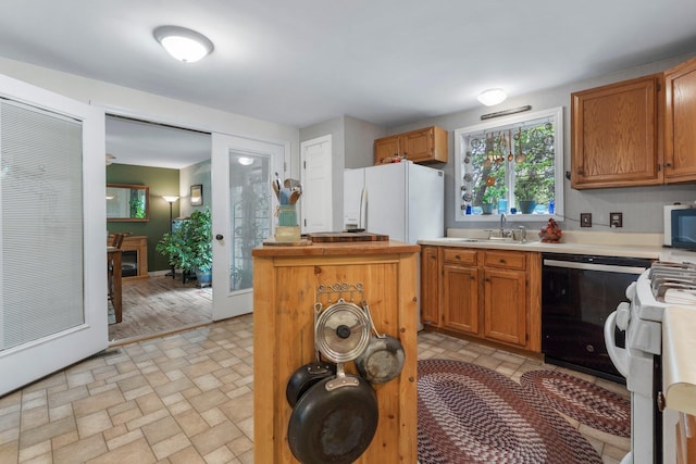 37 Thorndike Rd, Weare, NH 03281 - kitchen with a sink, white appliances, light countertops, brick patterned flooring, and brown cabinets