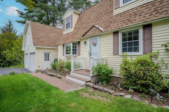 12 Emerald Cir, Goffstown, NH 03045 - view of front facade featuring a shingled roof, a garage, driveway, and a front lawn