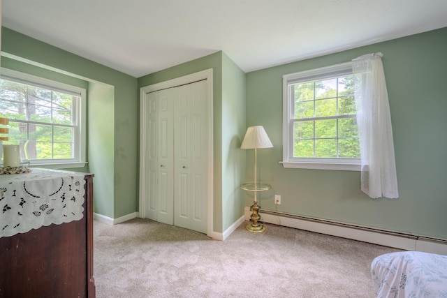 12 Emerald Cir, Goffstown, NH 03045 - carpeted bedroom with a baseboard heating unit, multiple windows, a closet, and baseboards