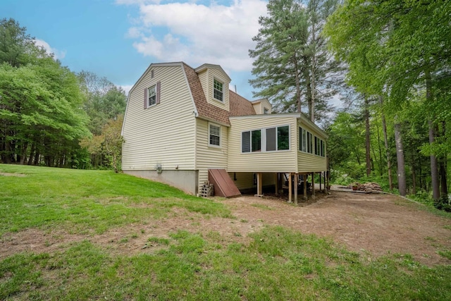 12 Emerald Cir, Goffstown, NH 03045 - back of property with a gambrel roof, a sunroom, a yard, and a shingled roof