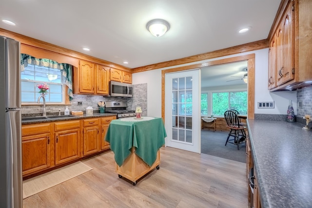 12 Emerald Cir, Goffstown, NH 03045 - kitchen with stainless steel appliances, backsplash, a sink, ceiling fan, and plenty of natural light