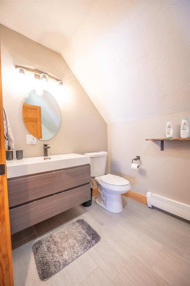 15 Spring Hill Rd, Dover, VT 05356 - bathroom with vaulted ceiling, baseboards, vanity, toilet, and a baseboard radiator