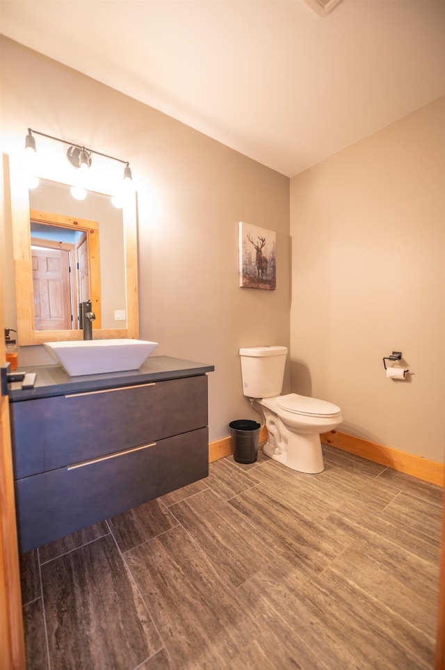 15 Spring Hill Rd, Dover, VT 05356 - bathroom with baseboards, wood finished floors, toilet, and vanity