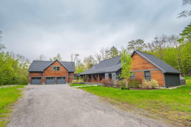 15 Spring Hill Rd, Dover, VT 05356 - view of front facade featuring an outbuilding, a front yard, a garage, and a shingled roof