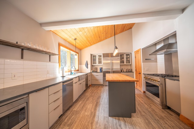 15 Spring Hill Rd, Dover, VT 05356 - kitchen with wooden counters, built in appliances, wall chimney exhaust hood, backsplash, and a sink