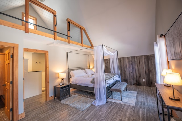 15 Spring Hill Rd, Dover, VT 05356 - bedroom with high vaulted ceiling, wood finished floors, and wood walls