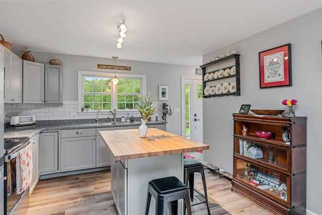 312 Browns Trce, Jericho, VT 05465 - kitchen with electric range, wooden counters, a sink, a breakfast bar, and gray cabinetry