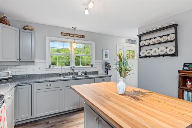 312 Browns Trce, Jericho, VT 05465 - kitchen featuring a sink, wooden counters, gray cabinetry, wood finished floors, and decorative backsplash