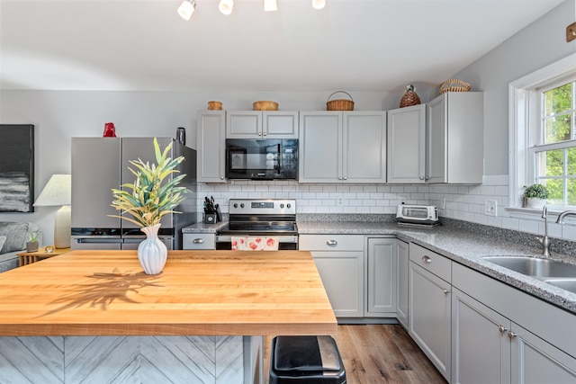 312 Browns Trce, Jericho, VT 05465 - kitchen featuring appliances with stainless steel finishes, a sink, decorative backsplash, wood finished floors, and wood counters