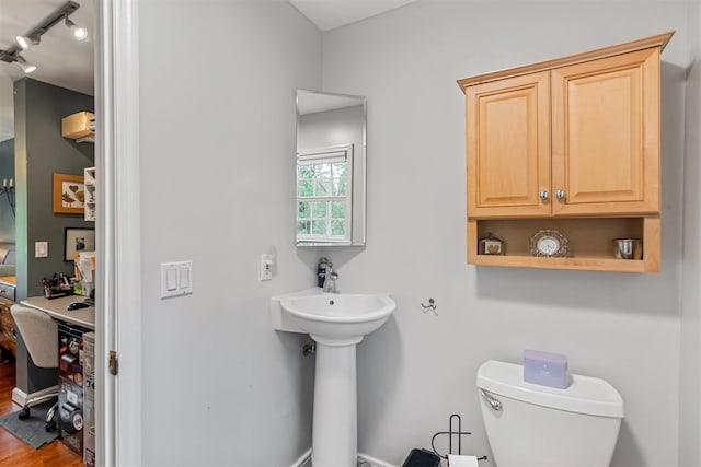 312 Browns Trce, Jericho, VT 05465 - bathroom with rail lighting, toilet, wood finished floors, and a sink