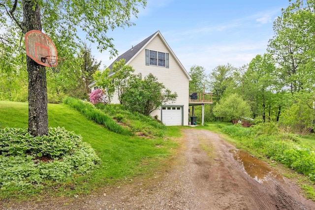 312 Browns Trce, Jericho, VT 05465 - view of home's exterior featuring dirt driveway, a garage, a wooden deck, and a yard
