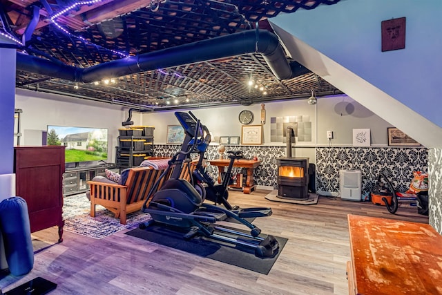 312 Browns Trce, Jericho, VT 05465 - workout area featuring a wood stove and wood finished floors