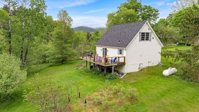 312 Browns Trce, Jericho, VT 05465 - rear view of property with a wooden deck, roof with shingles, a yard, and a view of trees