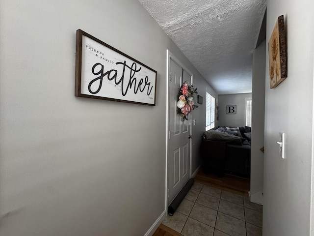 10 Irving Dr, Weare, NH 03281 - corridor with tile patterned floors, a textured ceiling, and baseboards