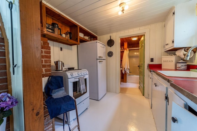 26 Don Gerry Rd, Bristol, NH 03222 - kitchen with white appliances, white cabinets, a sink, concrete flooring, and dark countertops