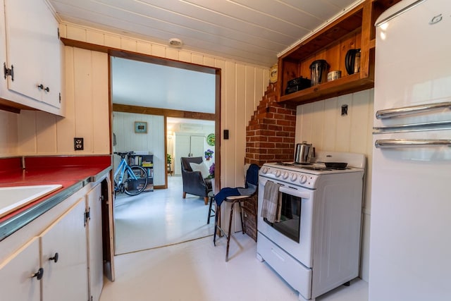26 Don Gerry Rd, Bristol, NH 03222 - kitchen with white appliances, white cabinetry, and wood walls
