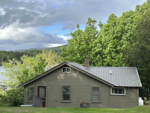26 Don Gerry Rd, Bristol, NH 03222 - back of property with a chimney and metal roof
