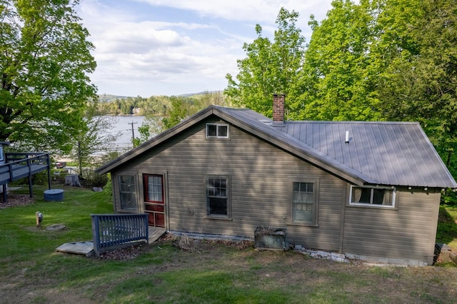 26 Don Gerry Rd, Bristol, NH 03222 - view of side of property with a chimney, a lawn, metal roof, and a deck with water view