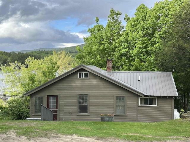 26 Don Gerry Rd, Bristol, NH 03222 - back of house featuring a chimney and metal roof