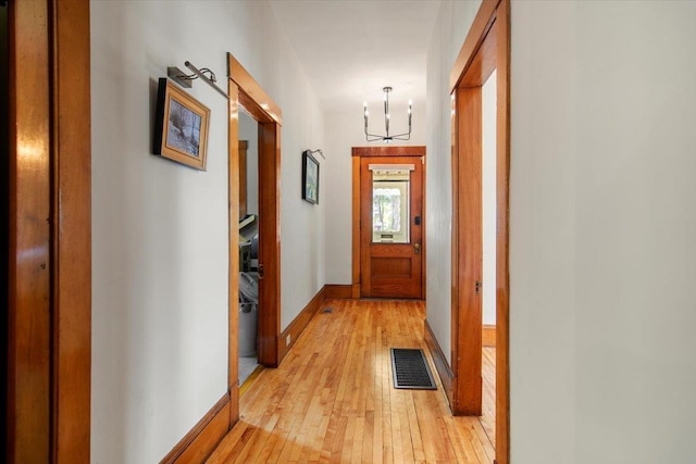 158 Clark Ave, Brattleboro, VT 05301 - hallway featuring a chandelier, light wood finished floors, and baseboards