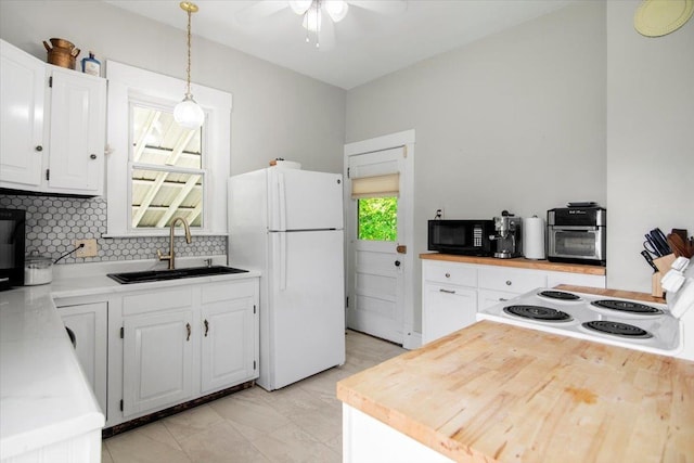 158 Clark Ave, Brattleboro, VT 05301 - kitchen with a sink, freestanding refrigerator, black microwave, a ceiling fan, and backsplash