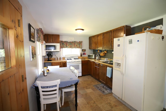 78 Daniels Pond Rd, Glover, VT 05839 - kitchen featuring white appliances, light countertops, a sink, light floors, and brown cabinetry