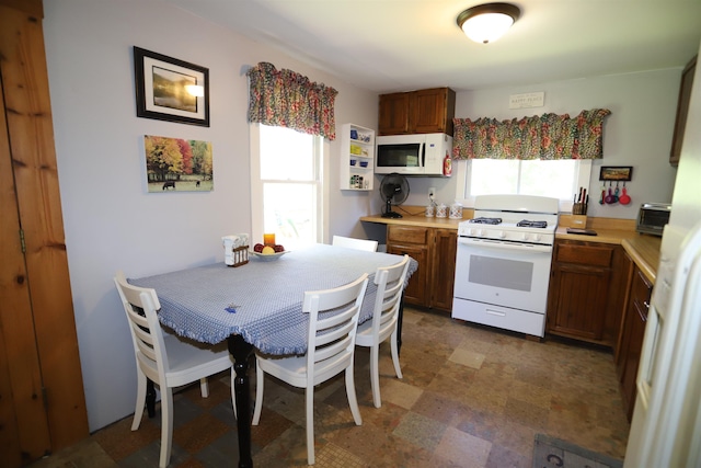 78 Daniels Pond Rd, Glover, VT 05839 - kitchen featuring white appliances, light countertops, and brown cabinets