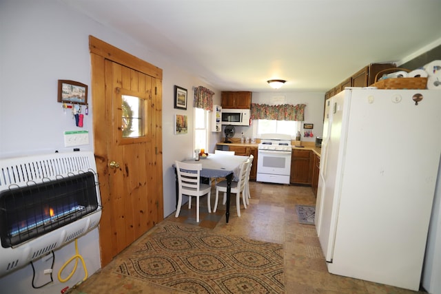 78 Daniels Pond Rd, Glover, VT 05839 - kitchen featuring white appliances, heating unit, light countertops, and brown cabinets