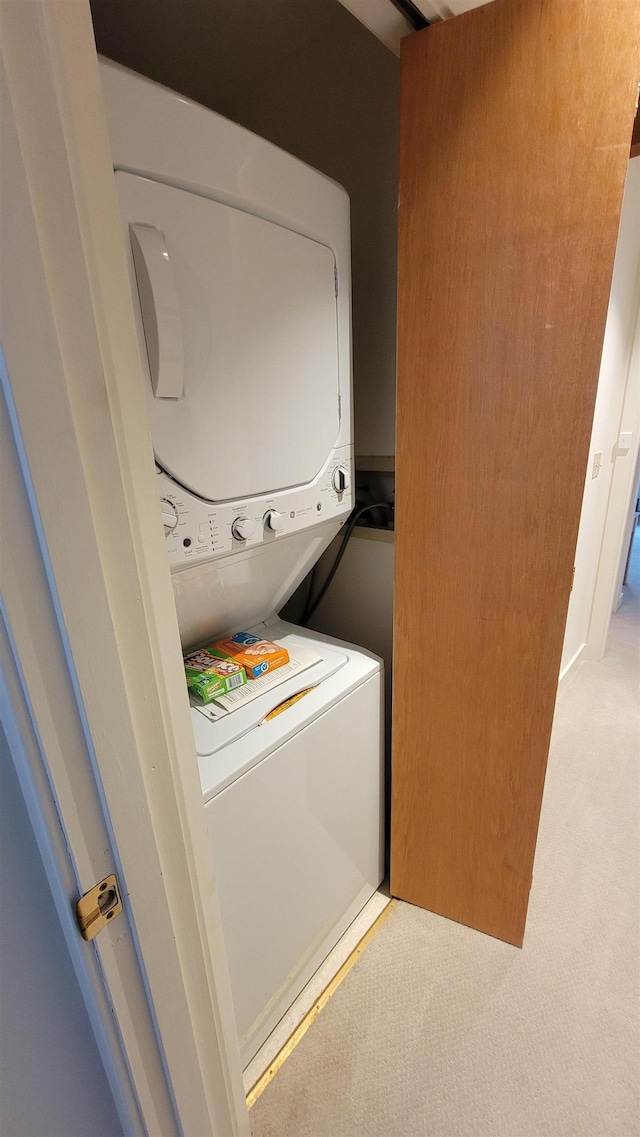 782 E Mountain Rd Unit C2, Killington, VT 05751 - laundry room with stacked washer and clothes dryer and light carpet
